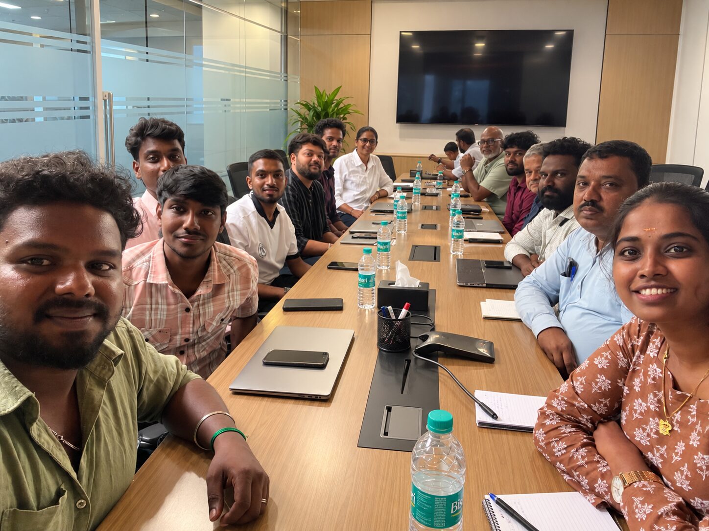 The Assurify team gathered around the table in a meeting room at the Chennai office